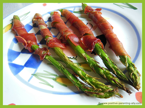 Delicious lunch snack for kids with asparagus and ham. 