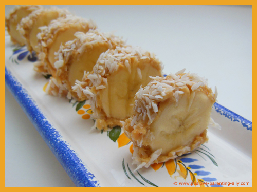 Quick after school snack: Banana Swiss roll with peanut butter and coconut.
