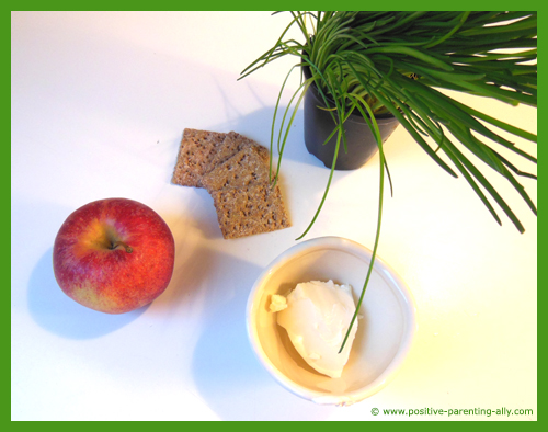 Ingredients for crackers with cream cheese mixed with chive.