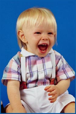 Photo of happy little toddler boy shouting