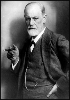 Famous photo of a stern looking Freud holding a cigar.
