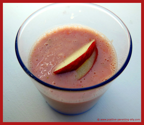 Pink fruit smoothie with pear, apple, melon, strawberry and a carrot.