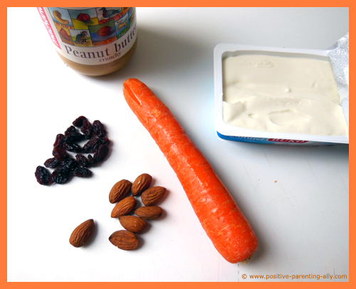 Ingredients for carrot snacks: carrots, cream cheese, peanut butter, raisins and almonds.