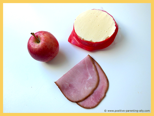 Ingredients for healthy snack for kids: simple apple, cheese and ham snack to make in no time.