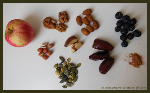 Ingredients for healthy Halloween snacks: nuts, berries, seeds, apple