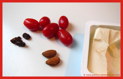 Ingredients for cheesy tomatoes: tomatoes, cream cheese, almonds and raisins.