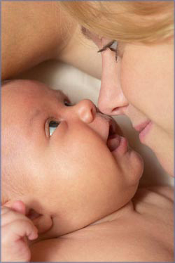 Intimate moment of mother and baby rubbing noses. 