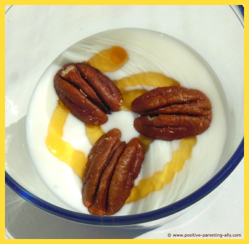 Healthy snack - pecan nuts on honey trail mixed with plain yogurt.
