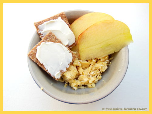 Quick snack for kids with scrambled eggs and apple slices