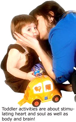 Showing love and affection are also important toddler learning games: Mother kissing her little boy.