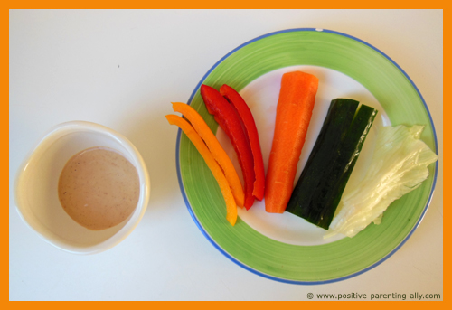 The colorful vegetable rainbow for kids with peanut butter dip. Easy snack recipe for toddlers.