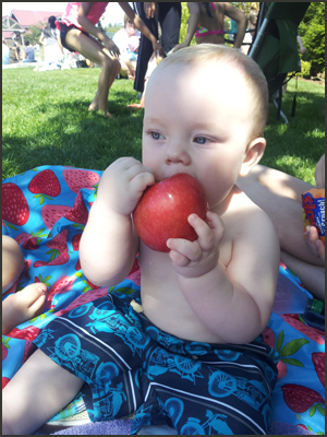 Child development stages for babies: little boy sitting by himself with no support.