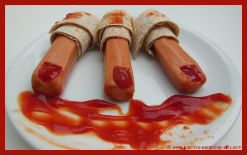 Healthy Halloween finger foods for kids. Three bloody Halloween fingers in bandages.