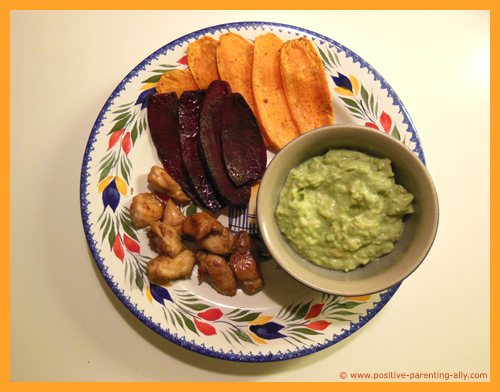 Healthy kids meal snacks: chicken nuggets, sweet potato and beetroot chips and avocado dip or guacamole.