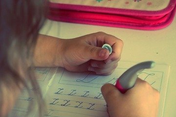 Girl writing and doing homework. 