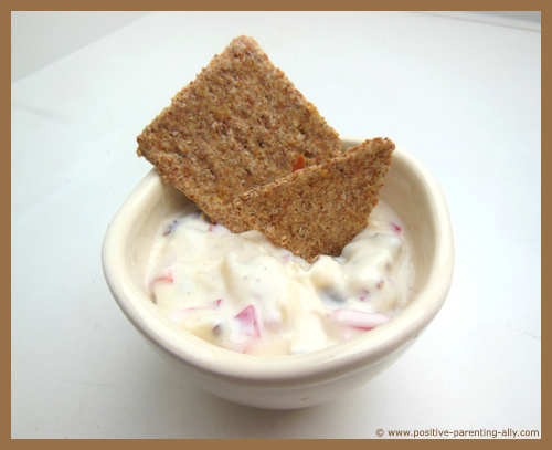 Delicious kids snack: whole grain cracker with cream cheese dip.