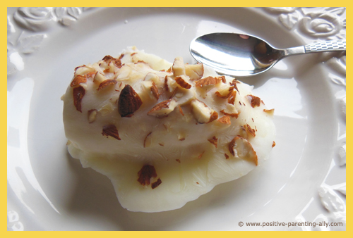 Delicious healthy fronzen snack with no sugar: frozen banana with chopped almonds and yogurt.