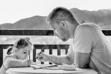 Father and daughter drawing or doing homework. 