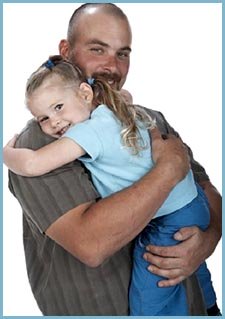 Photo of happy father hugging his little girl