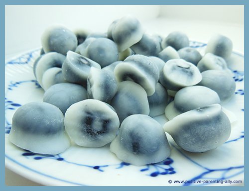 Delicious healthy frozen snacks for kids: frozen blueberries covered in plain yoghurt. 