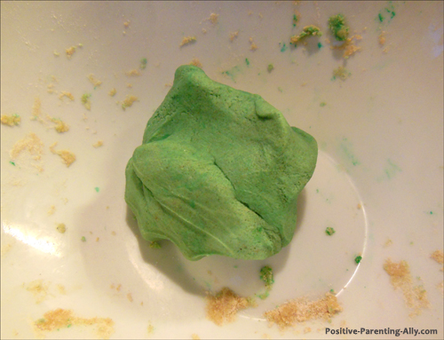 A good lump of green play doh ready to be used.