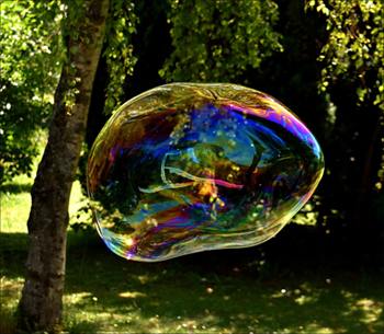 Fun kids activities: Blowing huge soap bubbles in the garden.