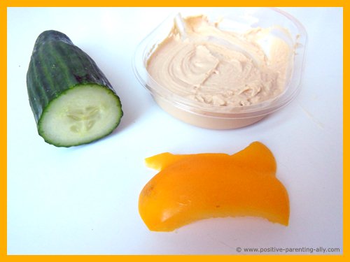 Ingredients for hummus snacks: cucumber, hummus and bell pepper.