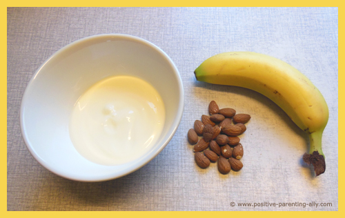 Ingredients for frozen snack treat with frozen banana with yogurt and almonds.
