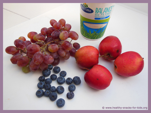 Ingredients for fruit smoothie: grapes, blueberries, apples and yoghurt.
