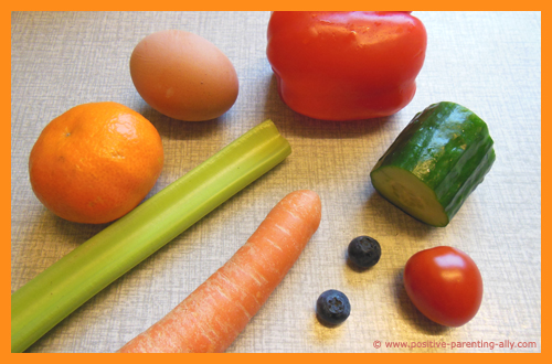 Ingredients for making funny veggie and fruit face on a plate.