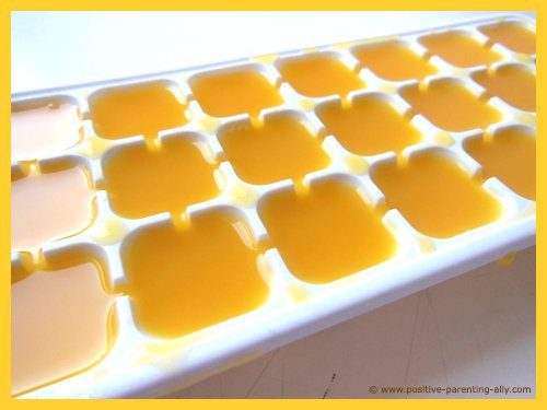 Ice cube tray with orange juice