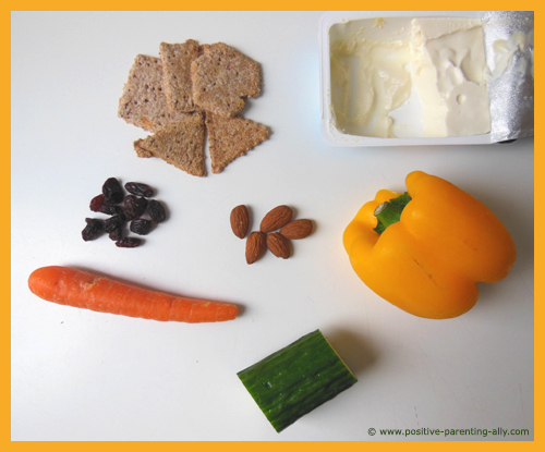 Fun snacks for kids: Fruits and vegetables for making funny faces on whole-grain crackers.