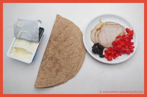 Ingredients for ham pin wheels: ham, tortilla, cream cheese, raisins and bell pepper.