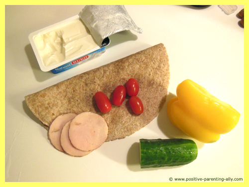 Tortilla snack ingredients: cream cheese, tomatoes, chicken, bell pepper and cucumber.