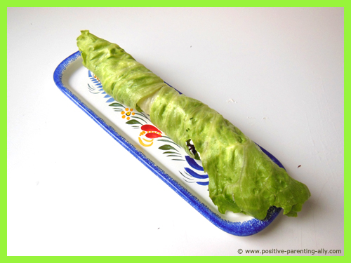 Healthy handy snack for kids: The finished rolled up lettuce with cream cheese and cranberries.