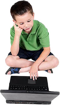 Little boy solving math multiplication games on his pc.