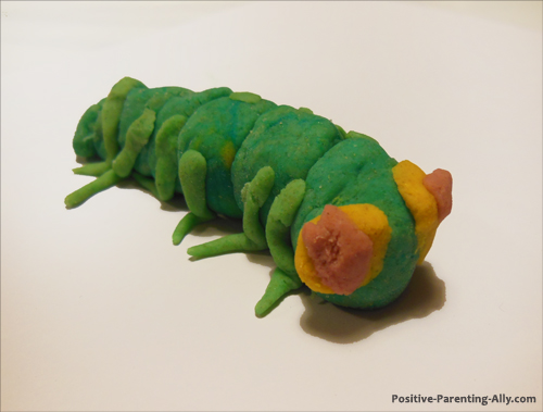 Cute green worm or bug made of homemade play doh.