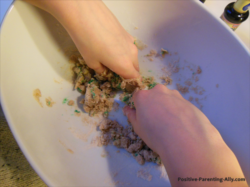 Kneading green homemade play doh