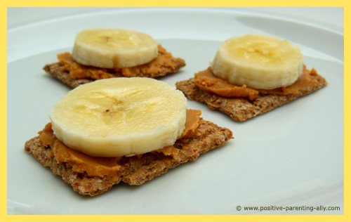 Quick easy snacks for kids with crackers, peanut butter and banana slices.