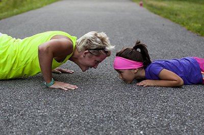 Mother and daughter doing sports together. 