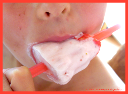 My son eating this healthy icecream treat made of strawberry yogurt and real fruit.