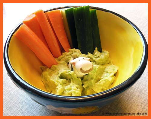 Simple snack recipes for kids to make quickly: Veggie sticks of carrots and cucumber with avocado dip.