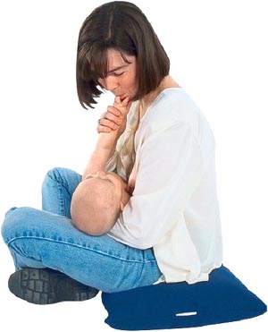 Picture of mom breastfeeding her baby while baby plays with mom's mouth