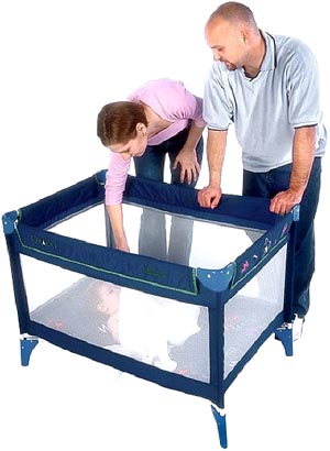 photo of parents, mom and dad, putting their baby to sleep in a crib