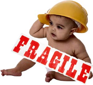 Image of baby in safety helmet and fragile sign.