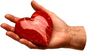 Male hand hand holding red glass heart.