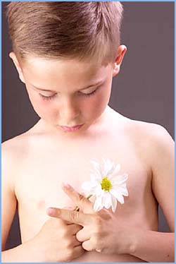 Healthy Parenting: Little boy holding a flower in his hands.