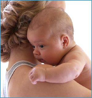 High need baby: picture of skin to skin contack between mother and baby. Mother carrying baby over her shoulder!