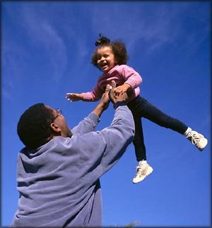 Parenting style test: Father throwing his little girl up into the air. 