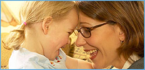 Use the power of the mirror effect in parenting. Photo of mother and daughter looking at each other and laughing!